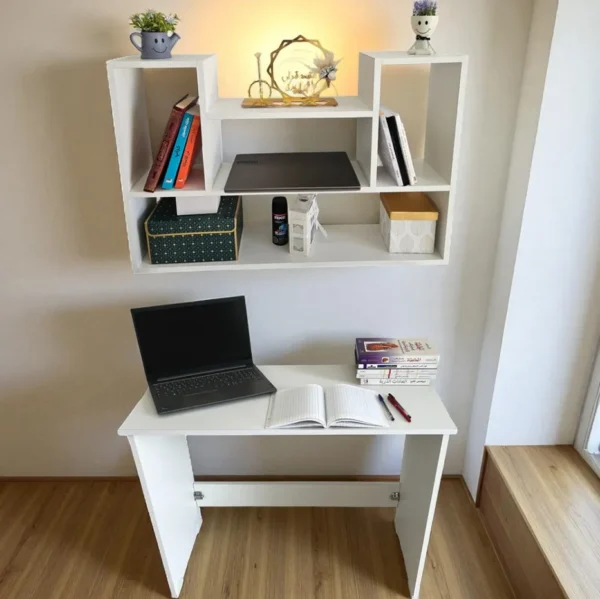Vue de côté d'un ensemble bureau et bibliothèque murale en bois, avec des livres et une plante, créant un espace de travail organisé.