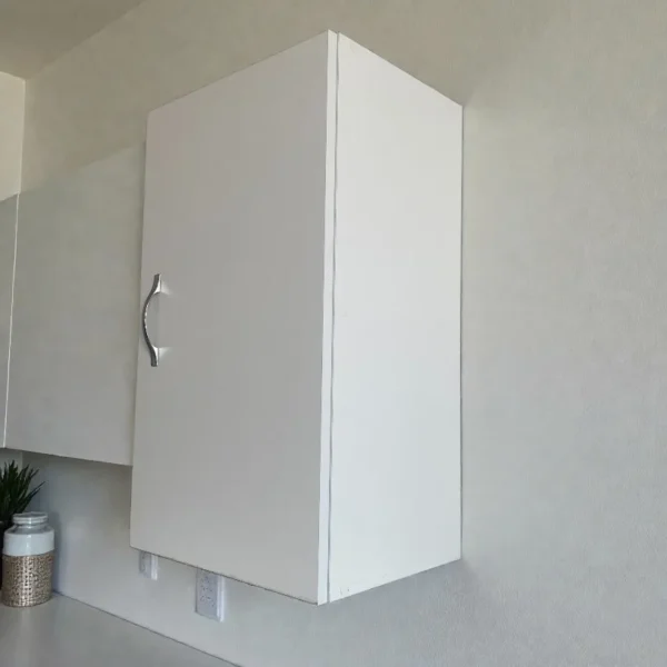 Petit meuble haut blanc fermé idéal pour rangement au-dessus des toilettes ou en pharmacie.