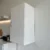 Vue de côté d'un placard mural blanc fermé installé au-dessus du plan de travail.