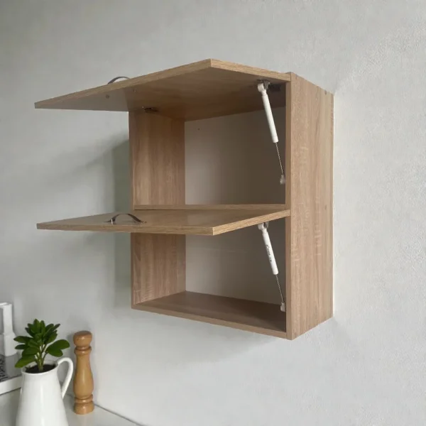 Meuble haut de cuisine à abattant vide illustrant le mécanisme de portes basculantes et le volume de stockage.